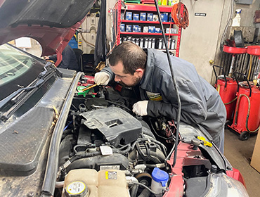 mechanic works under the hood